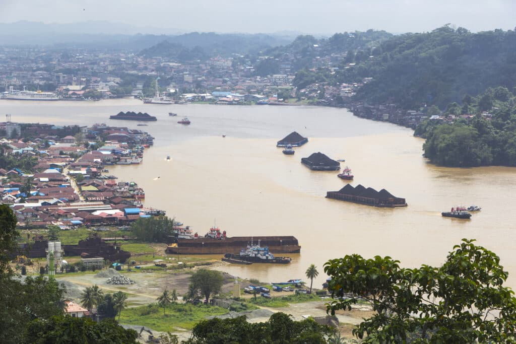 Coal being transported in Kalimantan, Indonesia, by open cargo boats